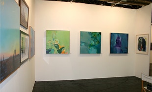 stand view with paintings by Annie Coxey
