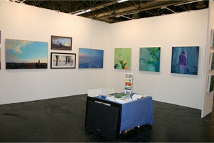 stand view with paintings by Annie Coxey and Oliver Rennert